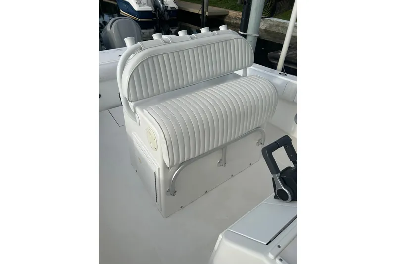 Slide: The Image of 2002 Regulator 32 Forward Seating boat with white cushioned seats and control panel. - 31