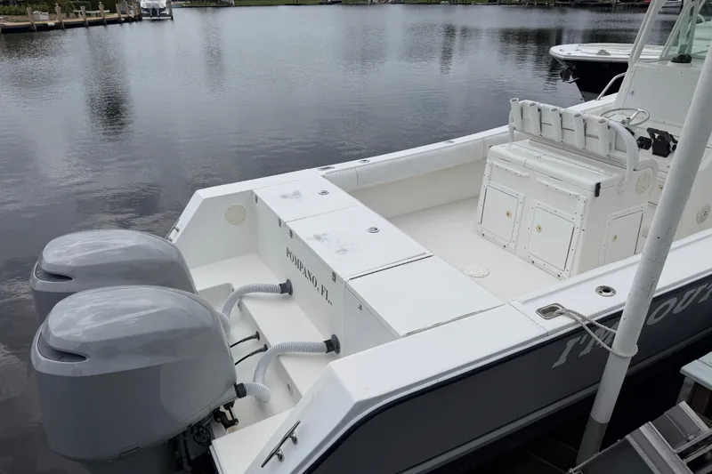 Slide: The Image of 2002 Regulator 32 Forward Seating boat docked with dual outboard motors. - 5
