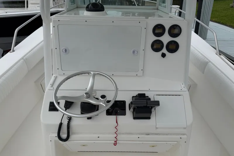 Slide: The Image of 2002 Regulator 32 Forward Seating boat dashboard with steering wheel and control panel. - 8