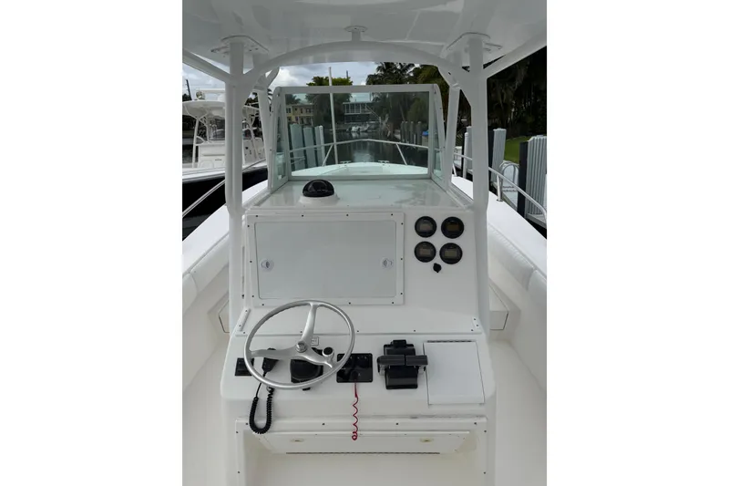 Slide: The Image of 2002 Regulator 32 Forward Seating boat helm with steering wheel and gauges. - 9