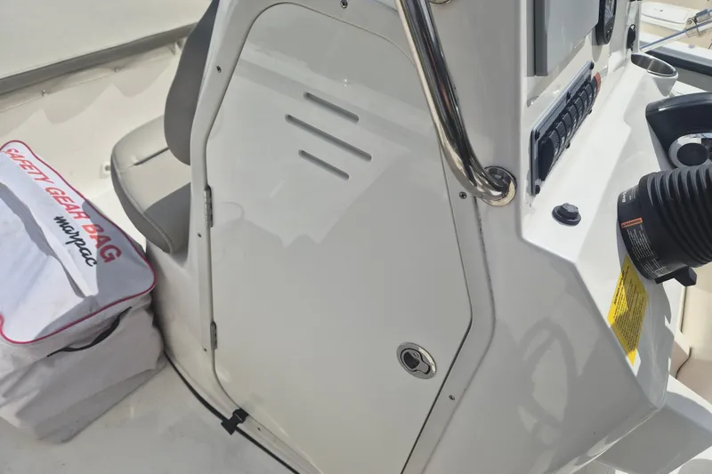 Slide: The Image of 2022 Key West 189 FS boat console with safety gear bag and controls. - 10