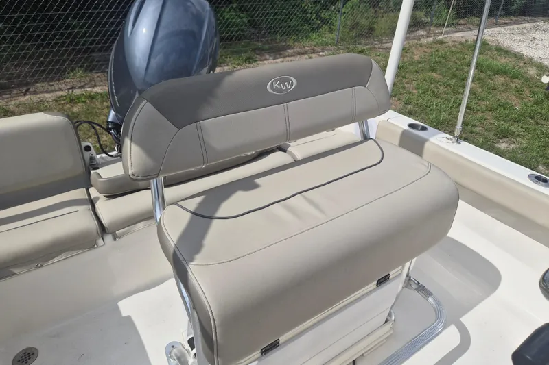Slide: The Image of 2022 Key West 189 FS boat interior with cushioned seating and motor. - 12