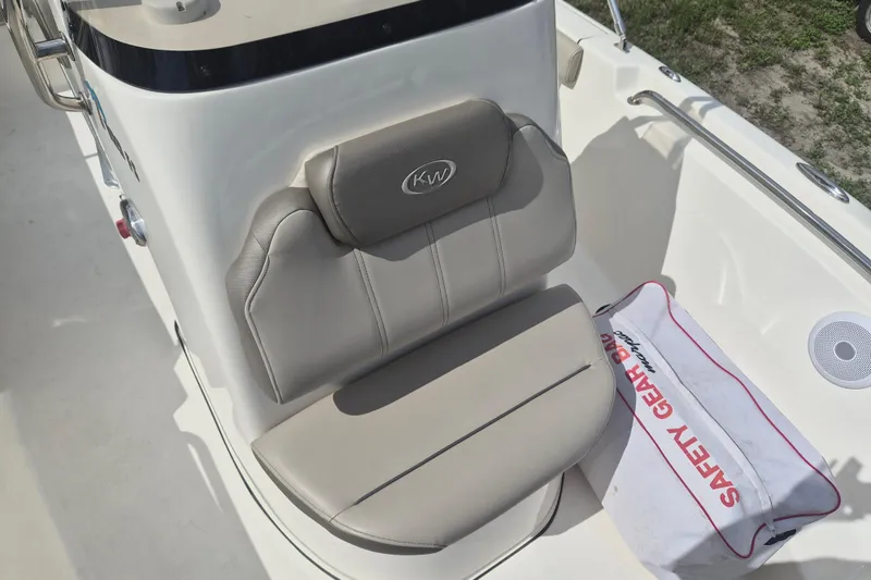 Slide: The Image of 2022 Key West 189 FS boat seat with safety gear bag on deck. - 15