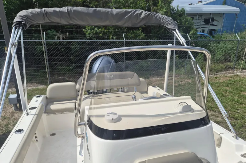 Slide: The Image of 2022 Key West 189 FS boat with seating and windshield, parked outdoors. - 16