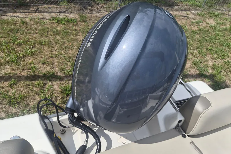 Slide: The Image of Outboard motor on 2022 Key West 189 FS boat, parked on grass. - 17