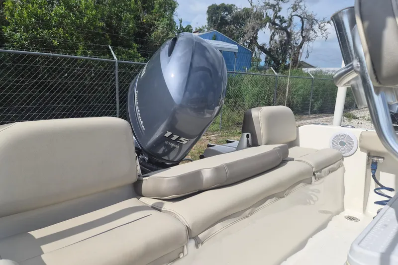 Slide: The Image of 2022 Key West 189 FS boat with Yamaha 115 engine, beige seating, outdoor setting. - 5