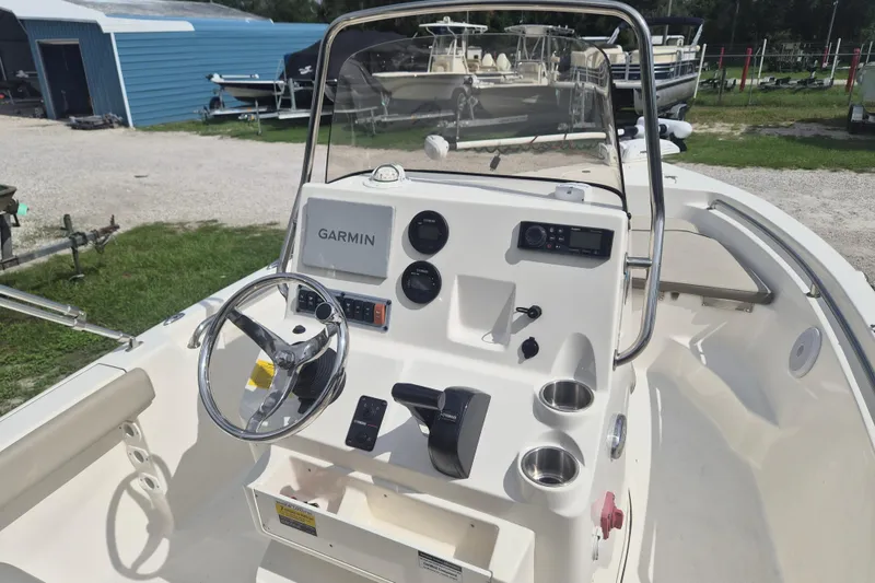 Slide: The Image of 2022 Key West 189 FS boat dashboard with Garmin navigation system and steering wheel. - 8