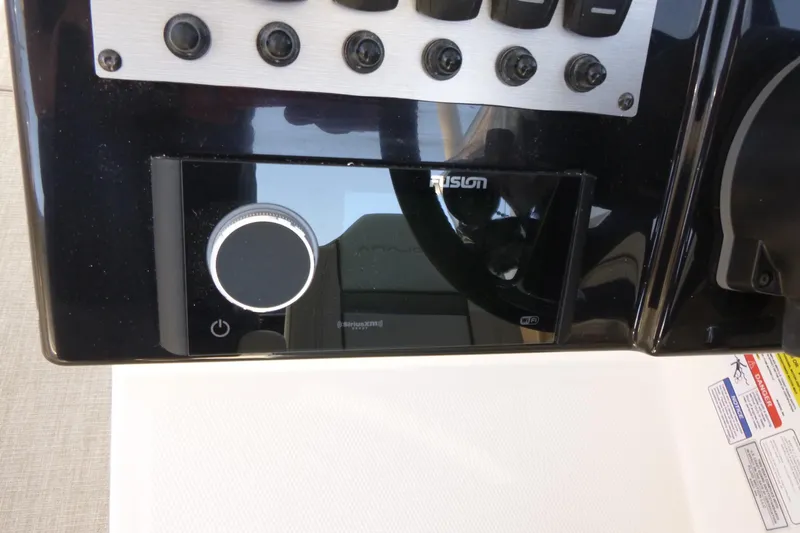 Slide: The Image of Control panel of 2026 Solara S-250 DC boat featuring Fusion audio system. - 17