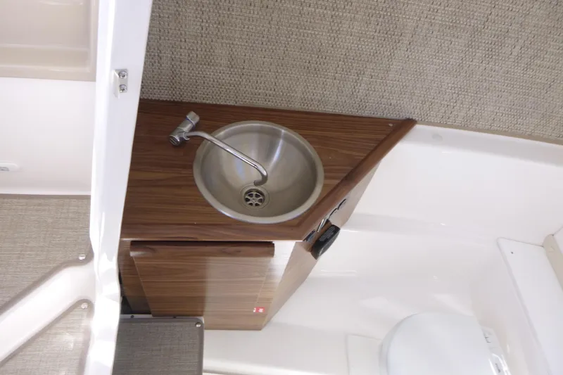Slide: The Image of Compact sink area in 2026 Solara S-250 DC boat interior. - 20