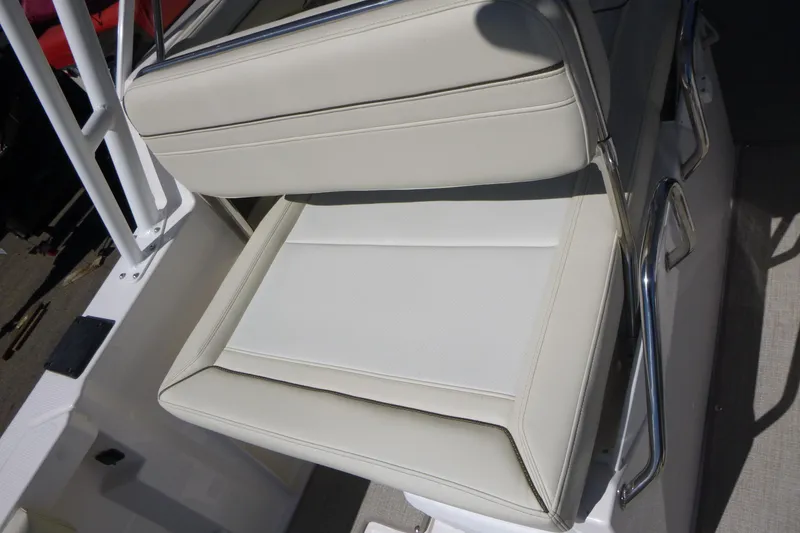Slide: The Image of Cream-colored seat on 2026 Solara S-250 DC boat, featuring sleek design and metal armrests. - 27