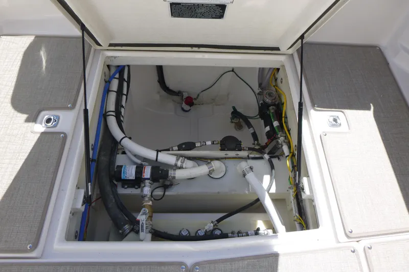 Slide: The Image of Open hatch of 2026 Solara S-250 DC boat showing internal wiring and plumbing. - 30