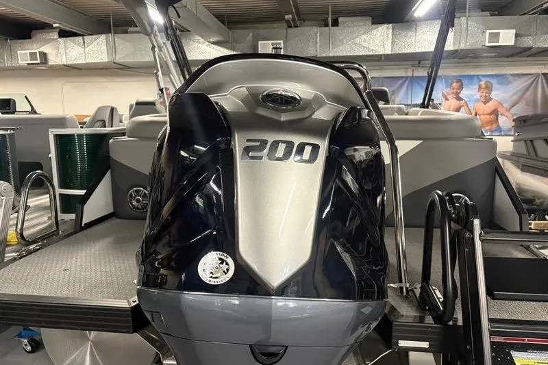 Slide: The Image of 2026 Evotti 523QL boat with a 200 horsepower engine in a showroom. - 3