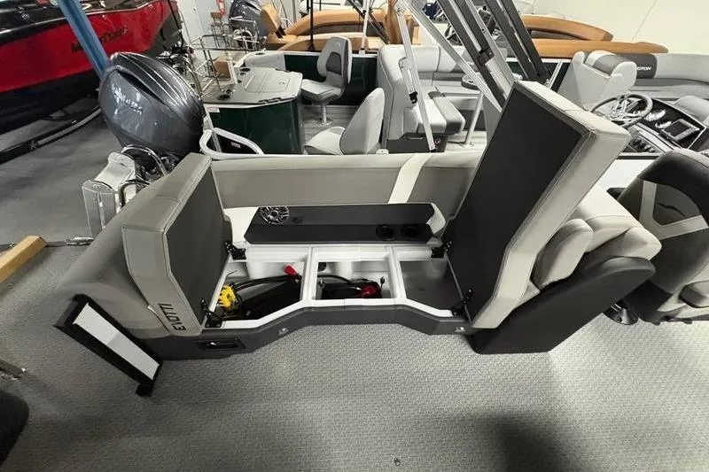 Slide: The Image of 2026 Evotti 523QL boat interior with open storage compartments and seating arrangement. - 9