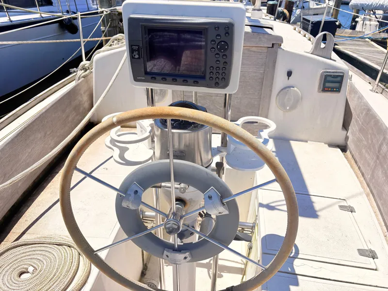Slide: The Image of Steering wheel of a 1972 Tartan 34 Classic yacht in harbor. - 12