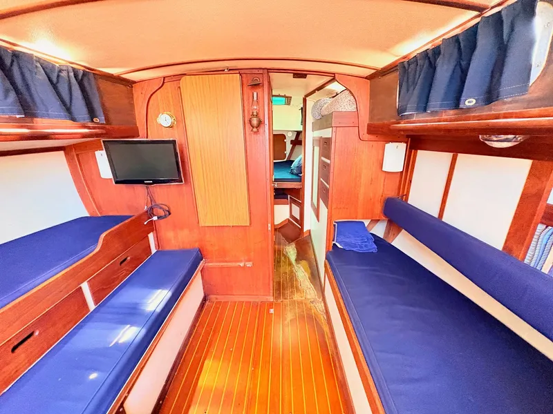 Slide: The Image of Interior of a 1972 Tartan 34 Classic yacht with blue upholstery. - 17