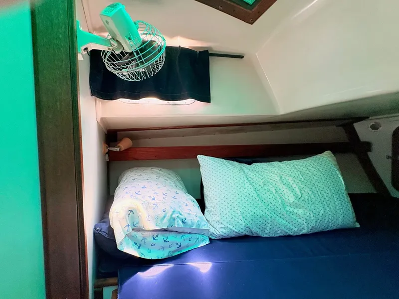 Slide: The Image of Interior of a 1972 Tartan 34 Classic yacht with bed and fan. - 29
