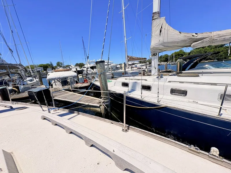 Slide: The Image of 1972 Tartan 34 Classic sailboat docked at marina. - 34