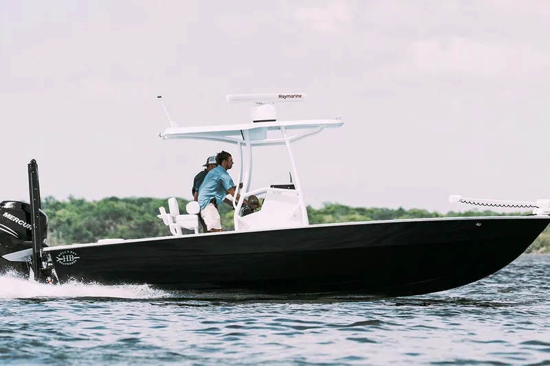 Slide: The Image of 2020 Hells Bay Ester boat cruising on water with two people onboard. - 6