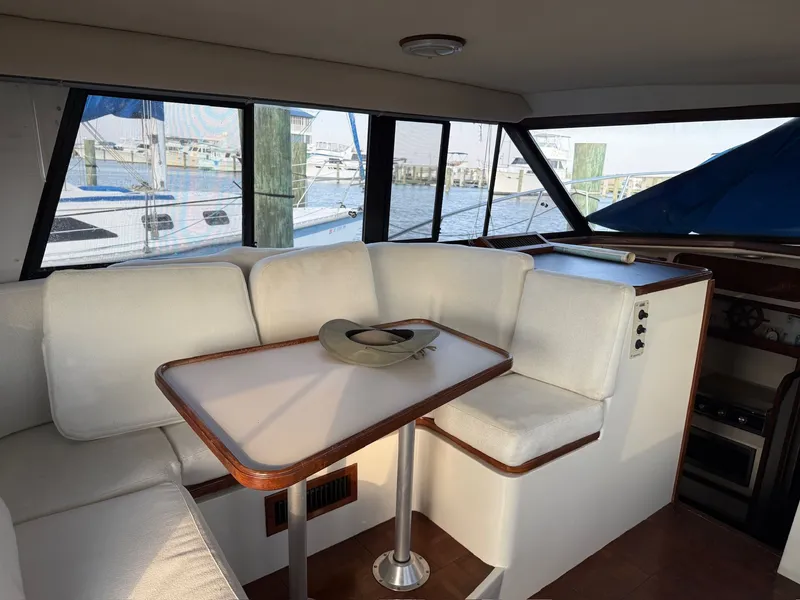 Slide: The Image of Interior of 1989 Carver 320 Voyager with seating area and table. - 15