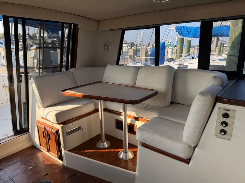 Slide: The Image of Interior of 1989 Carver 320 Voyager yacht with cozy seating area. - 18