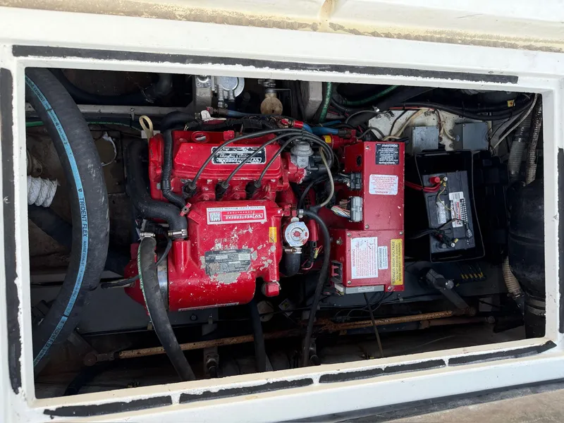 Slide: The Image of Engine compartment of a 1989 Carver 320 Voyager boat with red engine. - 19