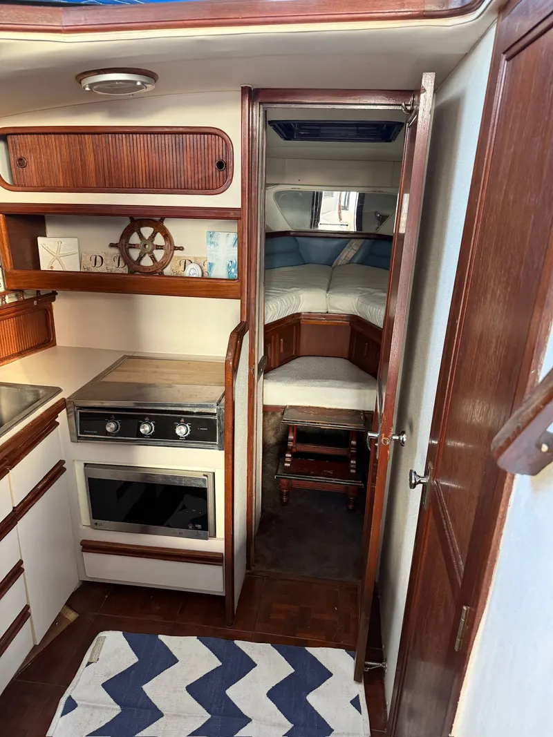 Slide: The Image of Interior of 1989 Carver 320 Voyager with kitchen and sleeping area. - 20