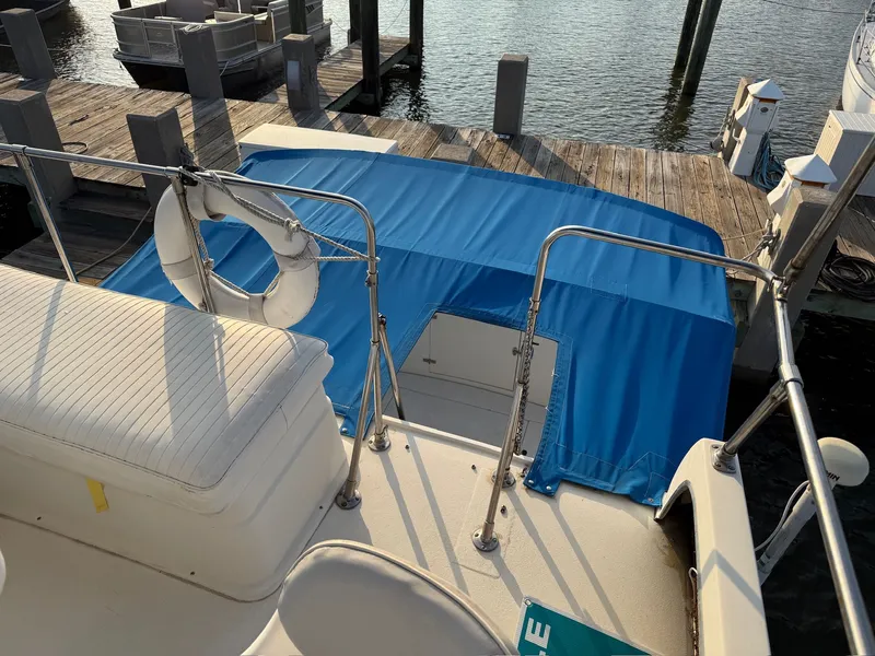 Slide: The Image of 1989 Carver 320 Voyager at dock with blue cover. - 3