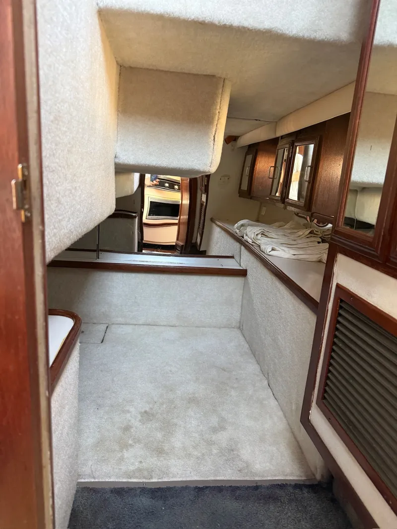 Slide: The Image of Interior of a 1989 Carver 320 Voyager yacht with carpeted flooring. - 8