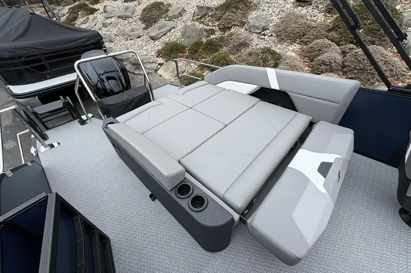 Slide: The Image of 2026 Evotti 525CS boat interior with gray seating and cup holders. - 12