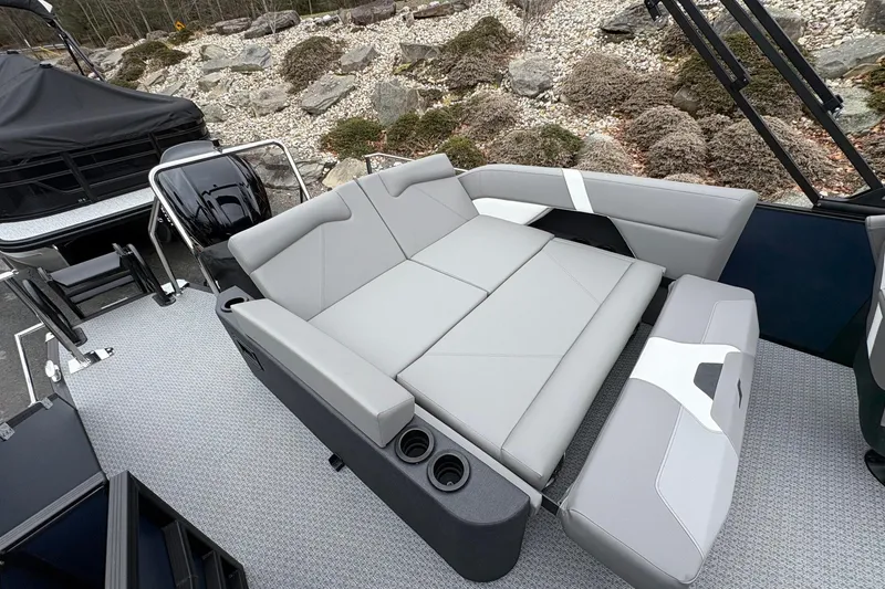 Slide: The Image of Luxurious seating on 2026 Evotti 525CS boat, featuring sleek gray upholstery and cup holders. - 13