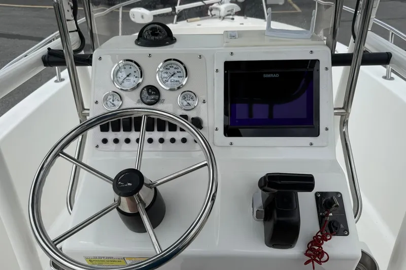 Slide: The Image of 2005 Sea Pro 190 Center Console dashboard with steering wheel and navigation instruments. - 11