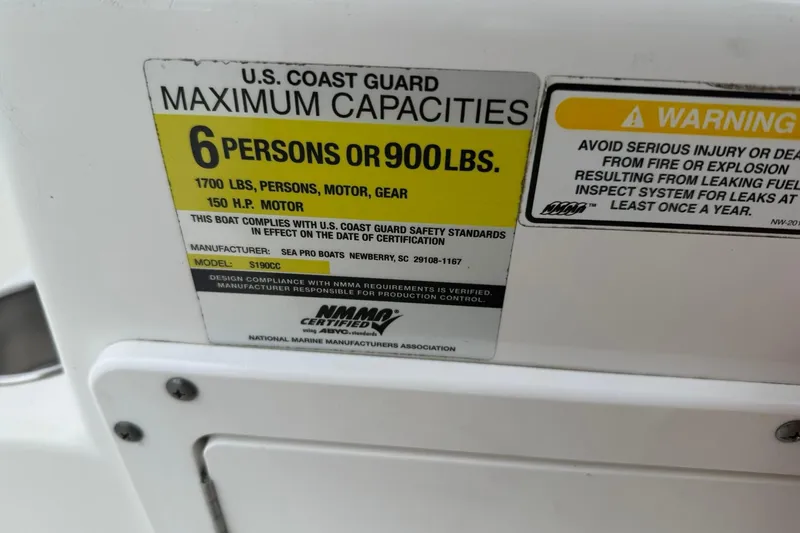 Slide: The Image of 2005 Sea Pro 190 Center Console capacity label, 6 persons or 900 lbs, safety warning. - 12