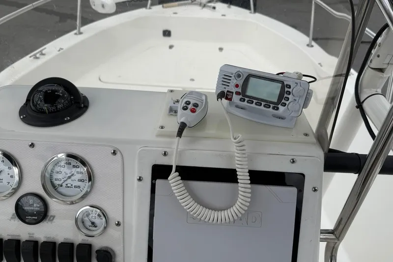 Slide: The Image of 2005 Sea Pro 190 Center Console dashboard with compass, gauges, and marine radio. - 13