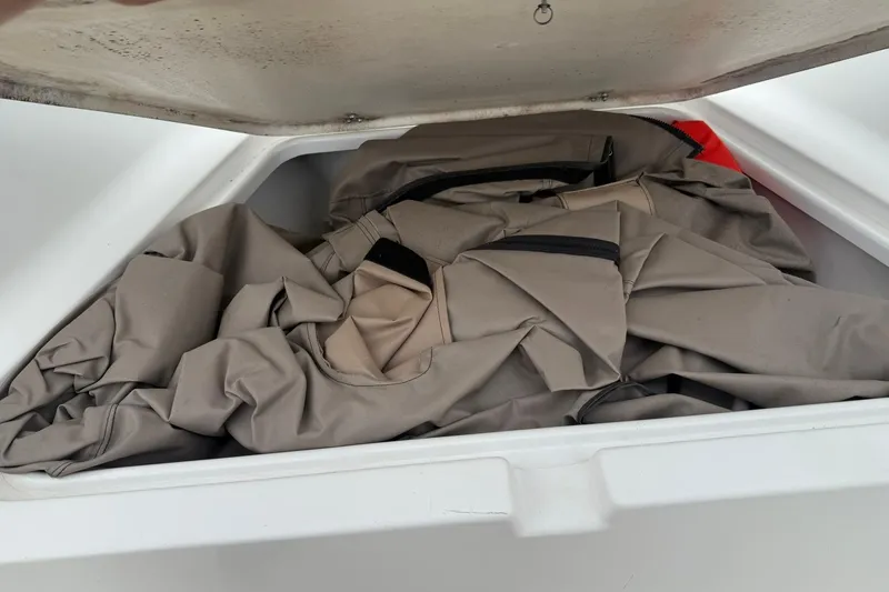 Slide: The Image of Storage compartment of 2005 Sea Pro 190 Center Console boat with canvas cover inside. - 17