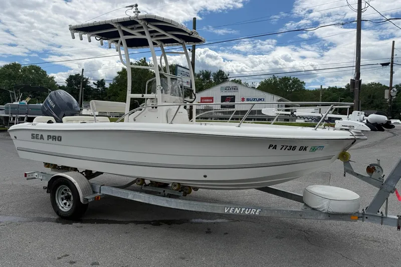 Slide: The Image of 2005 Sea Pro 190 Center Console boat on trailer, parked outdoors under cloudy sky. - 5