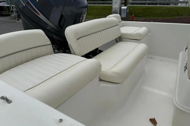 Slide: The Image of 2005 Sea Pro 190 Center Console boat with white cushioned seating and Yamaha engine. - 9