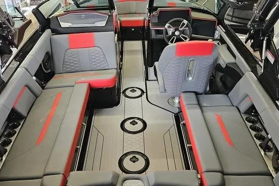 Slide: The Image of 2025 MasterCraft X22 boat interior with gray and red seating, modern design, and multiple cup holders. - 5