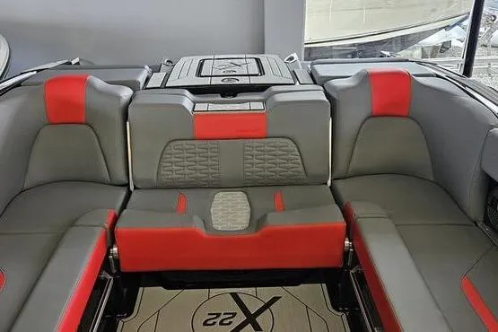 Slide: The Image of 2025 MasterCraft X22 boat interior with gray and red seating, showcasing modern design. - 7