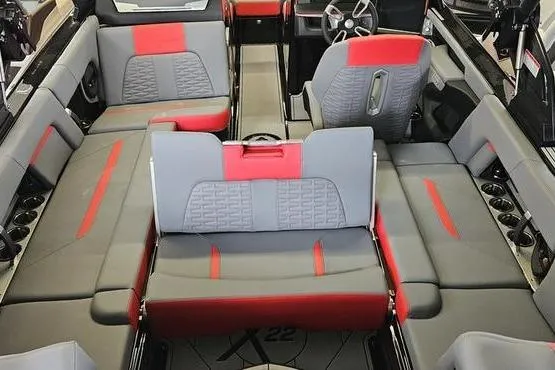 Slide: The Image of Interior of 2025 MasterCraft X22 boat with gray and red seating. - 8
