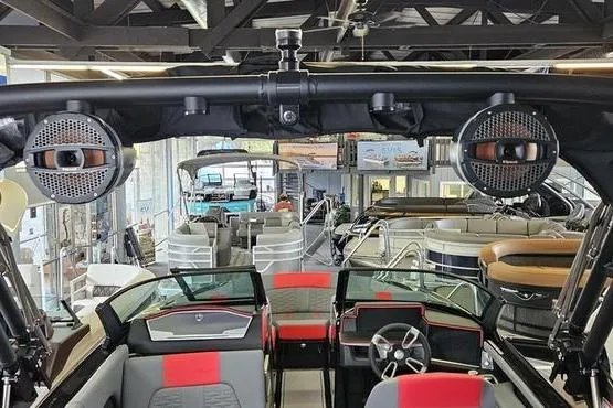 Slide: The Image of 2025 MasterCraft X22 boat interior with red and gray seating, showroom display. - 9