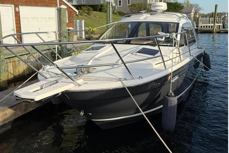 Slide: The Image of 2022 Cutwater C-24 Coupe at dock, sleek design. - 1