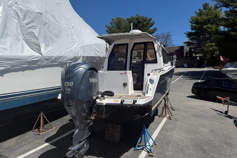 Slide: The Image of 2022 Cutwater C-24 Coupe boat with Yamaha 250 V6 engine on stands in a parking lot. - 14