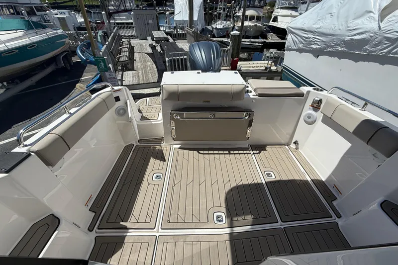 Slide: The Image of 2022 Cutwater C-24 Coupe boat interior with spacious deck and seating at marina. - 17