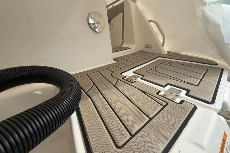 Slide: The Image of 2022 Cutwater C-24 Coupe interior with textured flooring and coiled hose. - 19