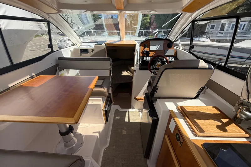 Slide: The Image of Interior of 2022 Cutwater C-24 Coupe boat with seating, table, and helm. - 21