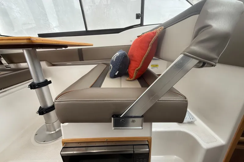 Slide: The Image of Interior of 2022 Cutwater C-24 Coupe with cushioned seating and table. - 28