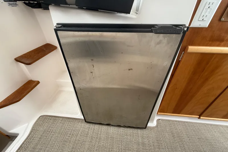 Slide: The Image of Stainless steel refrigerator in 2022 Cutwater C-24 Coupe boat interior. - 31