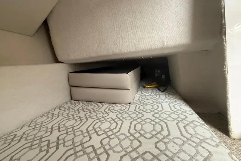 Slide: The Image of Interior cabin view of 2022 Cutwater C-24 Coupe with patterned flooring and cushioned seating. - 36