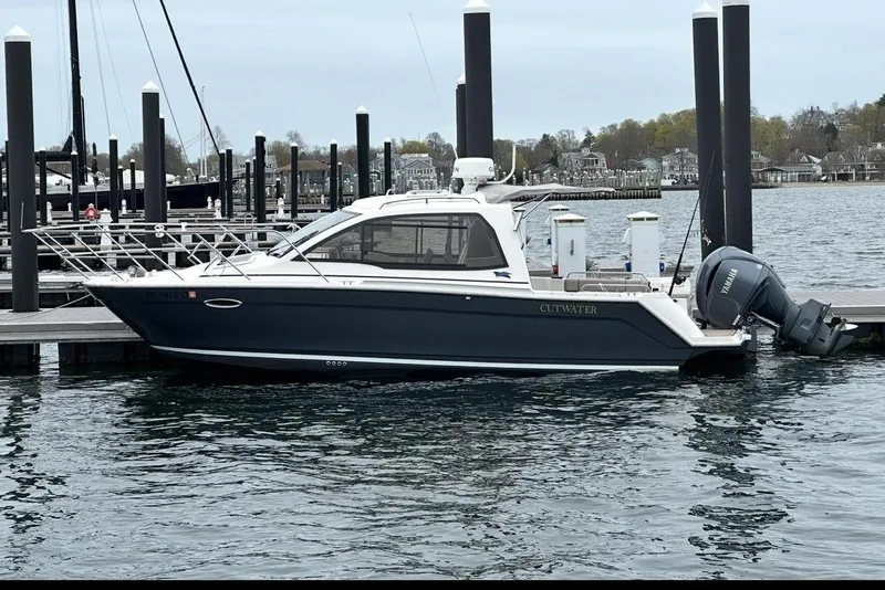 Slide: The Image of 2022 Cutwater C-24 Coupe docked, side view. - 4