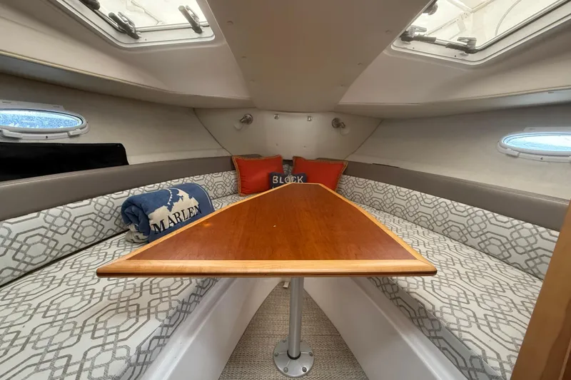 Slide: The Image of Interior of 2022 Cutwater C-24 Coupe with cozy seating and wooden table. - 43